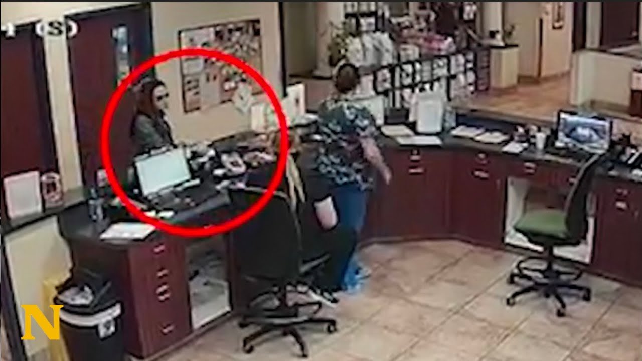 A shaking woman secretly slips a handwritten note to a